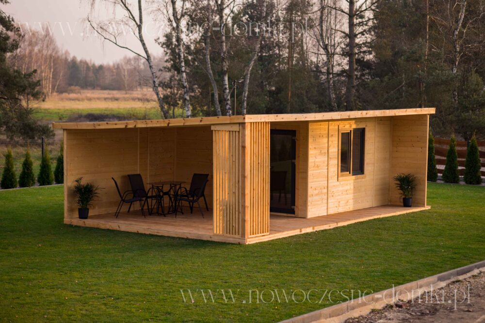 A garden pavilion with a terrace and windows for the office - A charming garden pavilion, made of wood, featuring a spacious terrace and office-like windows.