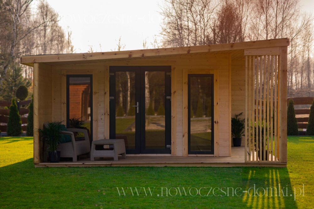 A garden house on a plot with a terrace and glass elements - perfect summer retreat for relaxation and leisure.