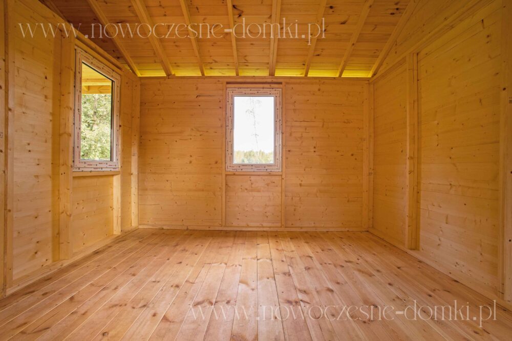 Przestronne wnętrze oraz przeszklone okna nowoczesnej altany drewnianej na działkę - harmonijne połączenie z naturą.